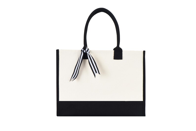 a black and white bag with a bow on it