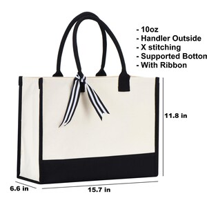 a white and black bag with a bow on it