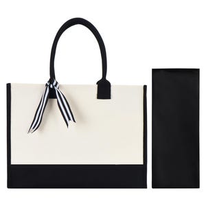 a black and white bag with a bow on it
