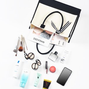 the contents of a purse are laid out on a white surface