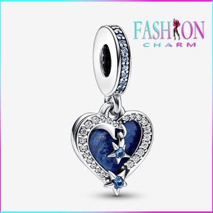 May include: A silver charm with a blue heart pendant, adorned with clear and blue crystals. The heart features a dark blue center and two blue star accents. The charm has the text "FASHION CHARM".