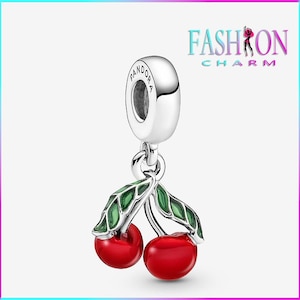 May include: A silver charm featuring two glossy red cherries with green leaves. The charm has a loop at the top with the word "PANDORA" engraved on it. The image also includes the text "FASHION CHARM".