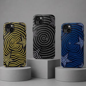 May include: Three smartphone cases featuring a spiral pattern and star motifs. The left case is yellow and black, the center case is dark gray and black, and the right case is blue and dark blue. Each case has a dual camera cutout at the top.
