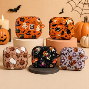 May include: Five square protective cases for wireless earbuds, each featuring distinct Halloween-themed patterns. The designs include orange, black, and lavender backgrounds decorated with illustrations of pumpkins, ghosts, witches, skulls, and bats.