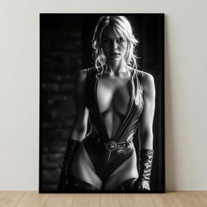 May include: Black and white framed print of a woman wearing a black leather bodysuit with a plunging neckline. The bodysuit is accessorized with a belt and gloves. The woman has blonde hair and is looking directly at the viewer.