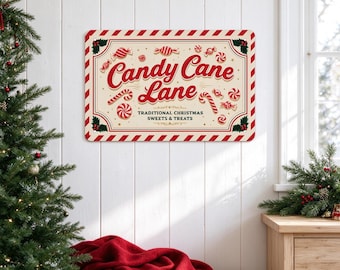 May include: A rectangular metal sign with a cream background and red striped border. The text reads Candy Cane Lane and TRADITIONAL CHRISTMAS SWEETS & TREATS. The design features red and white candy canes, peppermint swirls, and holly.