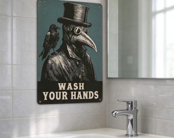 May include: A rectangular metal sign with a teal background featuring a plague doctor wearing a top hat and a crow perched on a shoulder. The text WASH YOUR HANDS is printed in bold cream letters at the bottom of the illustration.