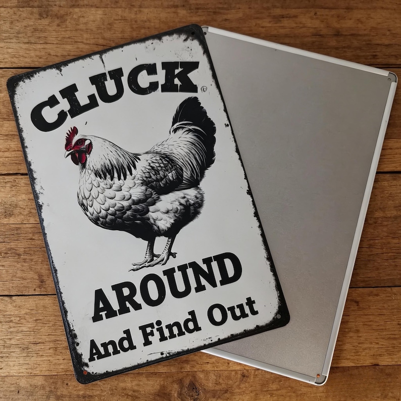 May include: A rectangular metal sign with a distressed finish. The sign features a detailed illustration of a rooster in black and white, with a red comb. The text "CLUCK AROUND And Find Out" is printed in bold, black letters.