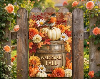 May include: A rectangular metal sign featuring a robin perched on a white pumpkin atop a wooden barrel. The design includes orange and white dahlias, red berries, and autumn leaves. The text WELCOME FALL is printed in gold on the barrel.