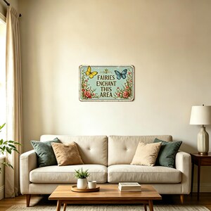 May include: A rectangular metal sign with a light blue background, featuring the text "Fairies Enchant This Area". The sign has a yellow butterfly on the left and a blue butterfly on the right, with floral accents.