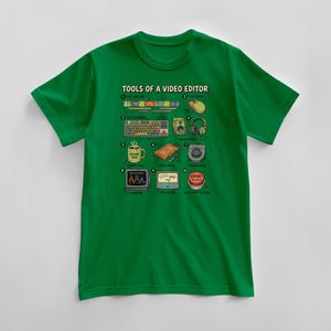 May include: Green t-shirt with a graphic illustrating "TOOLS OF A VIDEO EDITOR." The design includes a timeline, mouse, keyboard, speakers, headphones, coffee mug, hard drive, color wheels, monitor, meter, and an "EXPORT" button.