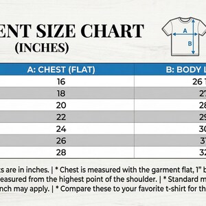 May include: A garment size chart in inches, with chest and body length measurements for XS to 3XL sizes. The chart includes a diagram of a t-shirt with labeled measurement points. Text at the bottom explains measurement details.