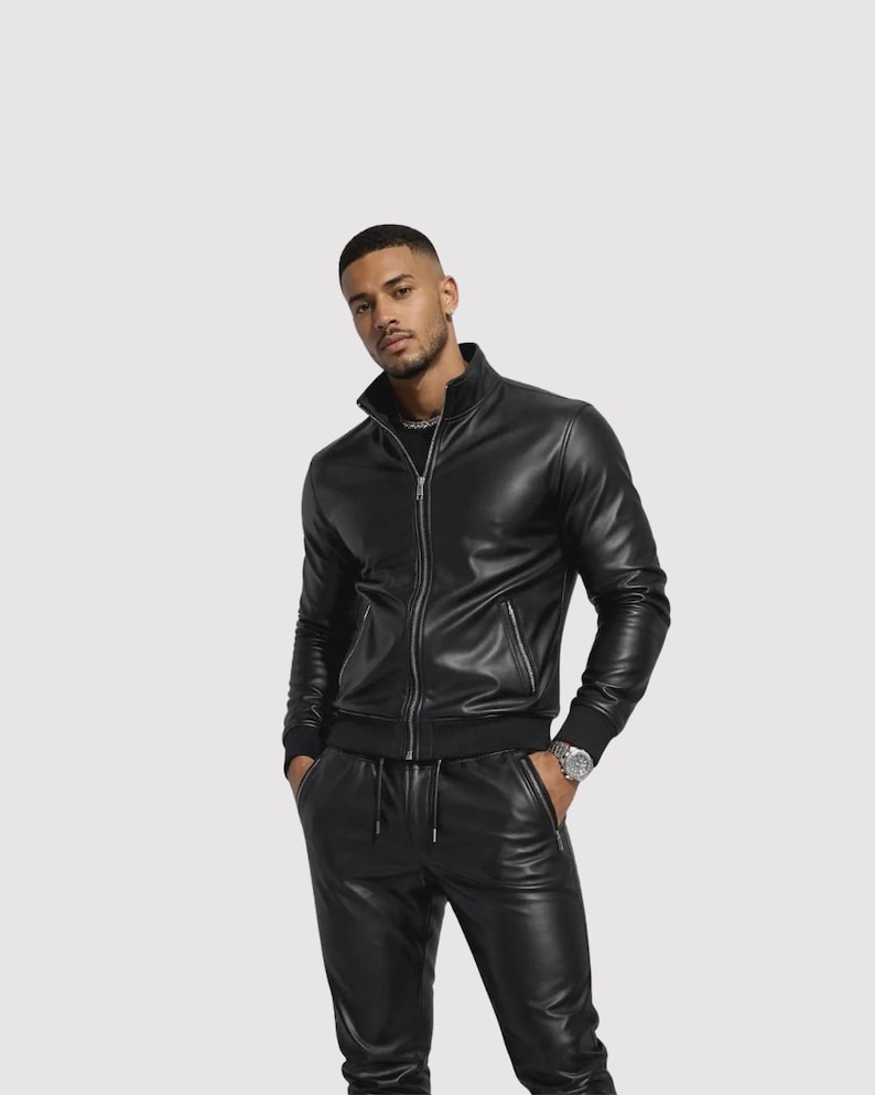 May include: A black leather jacket with a zip-up front and a stand-up collar. The jacket is paired with matching black leather pants. The outfit is sleek and modern, suitable for various occasions.
