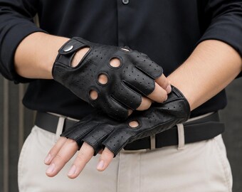 May include: Black fingerless gloves featuring a perforated design across the back and knuckles. The gloves include circular cutouts at the base of each finger and a small metallic snap button closure on the wrist strap for a secure fit.