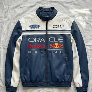 May include: A blue, white, and black racing jacket with the text "RACING SINCE '04", "ORACLE", and "Red Bull Racing". The jacket has a zip-up front, two front pockets, and a stand-up collar.