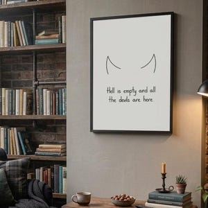 May include: A rectangular wall art print in a black frame featuring a minimalist line drawing of two devil horns above the text "Hell is empty and all the devils are here" in a simple black sans-serif font on a plain white background.