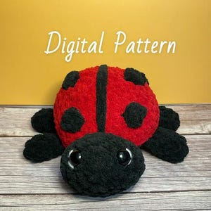 May include: A crocheted ladybug plush toy with black legs, head, and spots. The ladybug's body is red with a black stripe down the center.