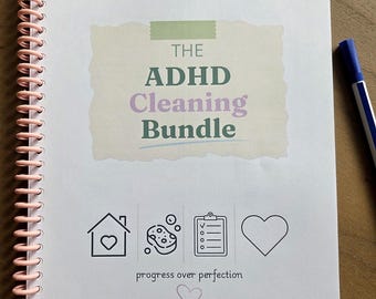 May include: A spiral-bound notebook with a light pink coil featuring the text THE ADHD Cleaning Bundle in green and purple. Below are icons of a house, sponge, checklist, and heart, with the text progress over perfection and AuDHDDesign.