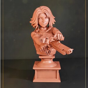 May include: A monochromatic terracotta-colored resin bust of a character with shoulder-length hair, holding two futuristic handguns pointed forward. The figure is mounted on a square pedestal base with a smooth, uniform finish and detailed features.