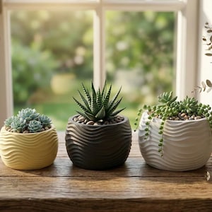 May include: A white ceramic mug with a black handle and the text "But First, Coffee" in a black, bold font. The mug is on a white surface.