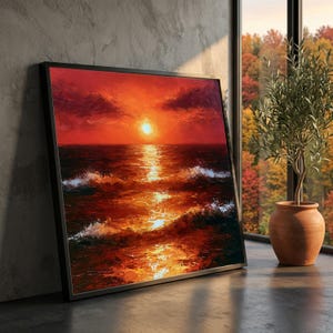 Op de afbeelding: Een vierkant ingelijst olieverfschilderij met een levendige zonsondergang boven de oceaan. De scène toont een heldere zon in het midden van de horizon, die een gouden reflectie werpt over donkere, getextureerde golven. De lucht is vol rode wolken.