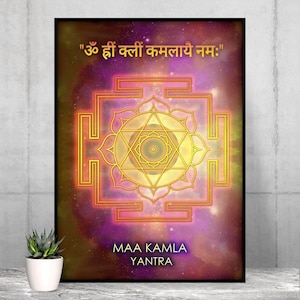 May include: Framed Maa Kamla Yantra art print. The artwork features a central geometric design in gold and orange, set against a cosmic purple and pink background. The text ""ॐ ह्रीं क्लीं कमलायै नमः"" is at the top, with "MAA KAMLA YANTRA" at the bottom.