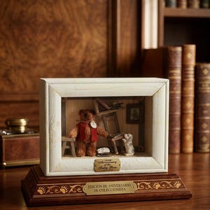 May include: A miniature diorama featuring a teddy bear wearing a red vest, a small dog, and a miniature room setting. The diorama is housed in a white-framed box and sits on a wooden base with the text "100th Anniversary of the Teddy Bear".