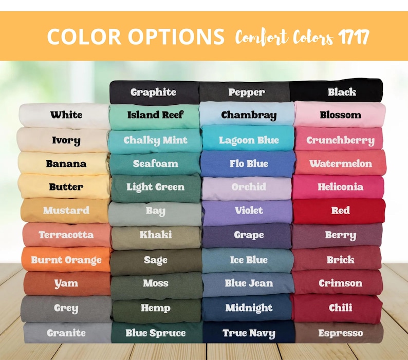 May include: A display of folded fabric samples in various colors, including white, black, blue, green, and red. The text "COLOR OPTIONS Comfort Colors 1717" is at the top, with color names like "Graphite," "Blossom," and "Espresso" labeling each fabric.