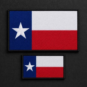 May include: Two rectangular embroidered patches featuring the Texas state flag design. Each patch displays a vertical blue stripe on the left with a single white star, followed by horizontal white and red stripes on the right, all with black borders.