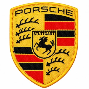May include: A shield-shaped embroidered patch featuring the Porsche logo in black text at the top. The design includes a yellow background with black antlers, red and black horizontal stripes, and a central crest with a black horse and the word STUTTGART.