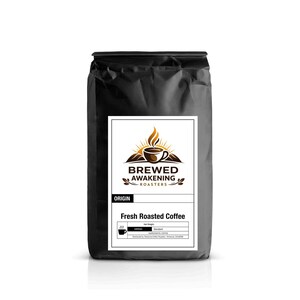 May include: A black bag of fresh roasted coffee with a white label. The label features the text "Brewed Awakening Roasters" with a coffee cup and sun design. The words "Fresh Roasted Coffee" are also on the label.