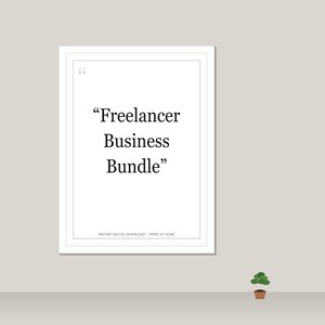 May include: A framed white print with the text "Freelancer Business Bundle" in black. The print is on a light grey wall, with a small potted plant on a shelf below.