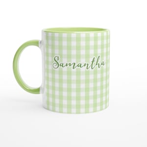 May include: A white ceramic mug with a green handle and interior. The exterior features a light green and white gingham pattern and the name "Samantha" in a cursive font.