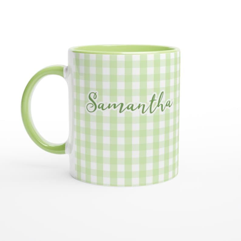 May include: A white ceramic mug with a green handle and interior. The exterior features a light green and white gingham pattern and the name "Samantha" in a cursive font.