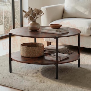 May include: A round coffee table with a dark wood grain finish and black metal legs. The table features two tiers, with a vase of dried flowers and stacked books on top, and a woven basket and folded textile on the lower shelf.