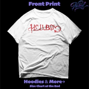 May include: White t-shirt with the red word "HELLBOY" in a stylized font across the front. The shirt has a crew neck and short sleeves. The text "Hoodies & More" and "Size Chart at the End" are at the bottom of the image.