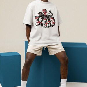 White oversized tee product photo on a model, highlighting Title Fight centered on the torso.