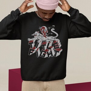 White pullover hoodie back view in a cafe-style setting, featuring title fight clearly on the back.