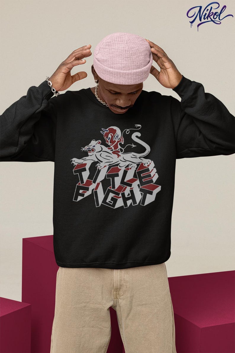 White pullover hoodie back view in a cafe-style setting, featuring title fight clearly on the back.