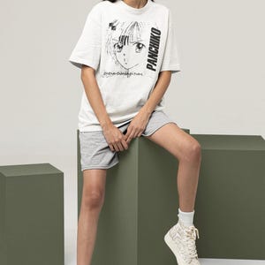 Studio lifestyle image of a white short-sleeve t-shirt, showcasing panchiko deathmetal album on the front print zone.