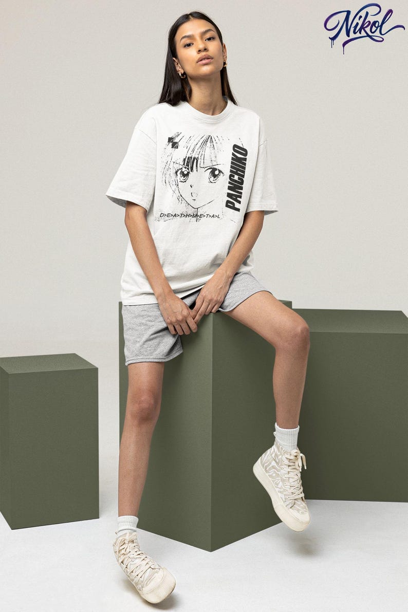 Studio lifestyle image of a white short-sleeve t-shirt, showcasing panchiko deathmetal album on the front print zone.