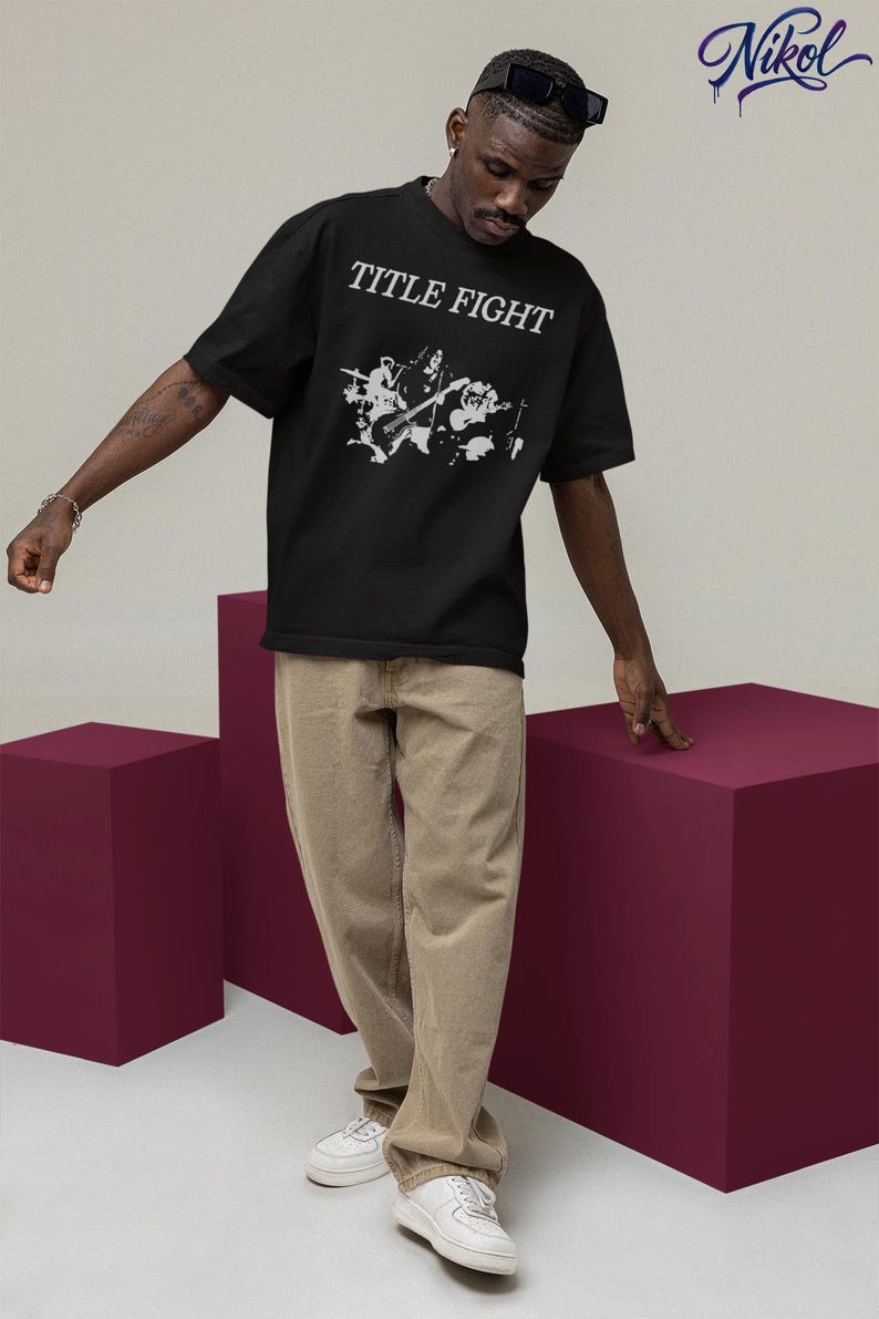 Outdoor lifestyle shot of a white unisex t-shirt, front print featuring Title Fight on the chest area.