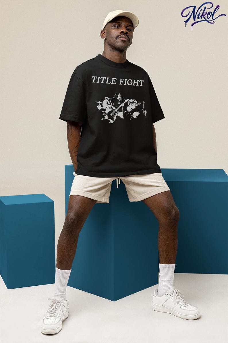 White tank top product preview on sand with palm leaves, front print customized with Title Fight.