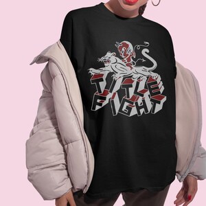 Studio photo of a model in a white t-shirt, front print preview featuring title fight.