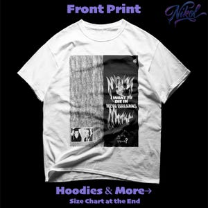 May include: White t-shirt with a graphic print. The design features a split composition with a textured grey section and a black section with the text "I WANT TO DIE IN NEW ORLEANS" and "GRAVE?". Includes two small portrait images.