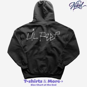 May include: Black hooded sweatshirt with the text "Lil Peep" in white, stylized lettering on the back. The upper right corner features the signature "Nikol" in a cursive font. The bottom of the image has the text "T-shirts & More" and "Size Chart at the End".