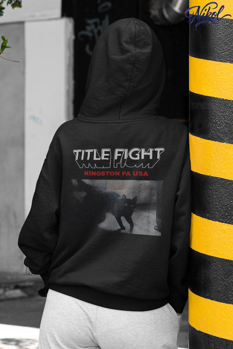 E-commerce lifestyle mockup of a white t-shirt on a model, front print shown as Title Fight.