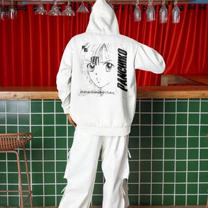 White hoodie worn by a model, rear view with panchiko deathmetal album printed on the back in a lifestyle scene.