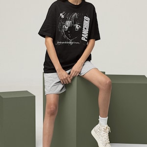 Studio photo of a model in a white long-sleeve tee, front print preview with Panchiko deathmetal album.