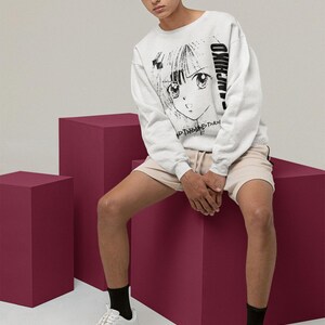 Model wearing a white long-sleeve shirt in a relaxed seated pose, displaying panchiko deathmetal album on the front.